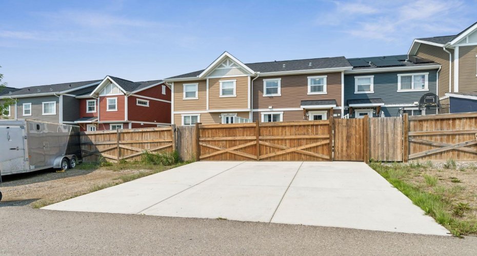 A paved rear parking pad provides convenient off-street parking