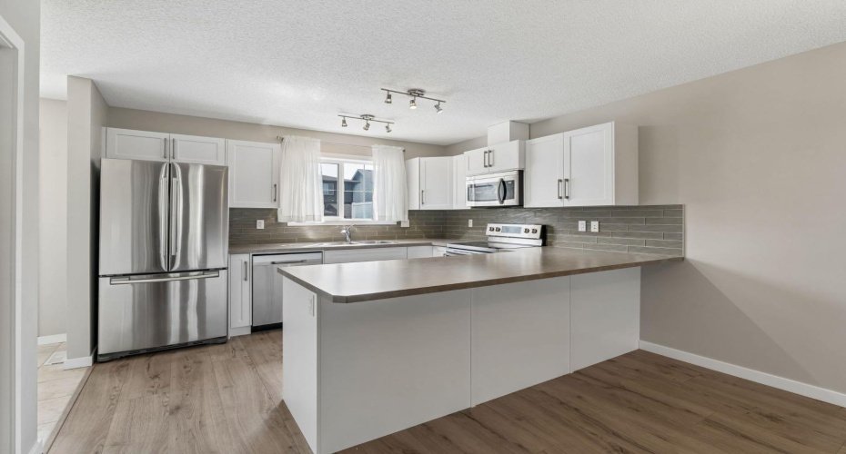 The kitchen is the heart of the home, thoughtfully designed for everything from busy weekday mornings to weekend baking sessions. Gather around the oversized peninsula, prepare meals with ease, and stay connected to family and guests every step of the way.