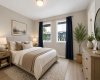 Photo virtually staged to showcase the primary bedroom with furniture