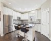 This beautifully appointed kitchen features a large island, updated stainless steel appliances, and an ideal blend of style, comfort, and functionality.
