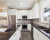 Beautiful granite countertops take center stage in this gorgeous kitchen, complemented by abundant cabinetry and ample storage space for exceptional style and everyday functionality.