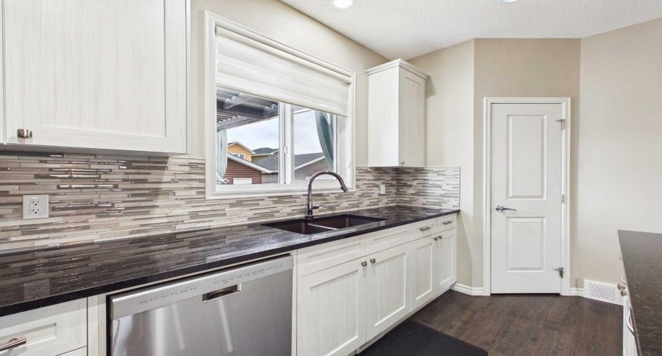 The deep kitchen sink is perfectly positioned beneath a window overlooking the backyard, making it easy to keep an eye on the kids while preparing meals or tackling everyday tasks.