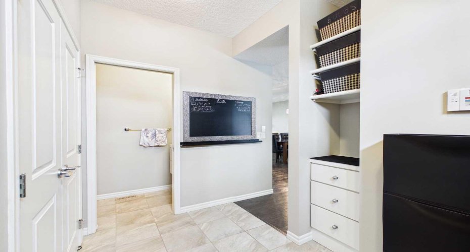 The spacious mudroom features a well-designed built-in, providing the perfect place to neatly tuck away coats, shoes, backpacks, and everyday essentials.