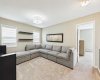 The inviting upstairs bonus room offers flexible living space, creating the perfect retreat for movie nights, quiet evenings, or winding down before bedtime.