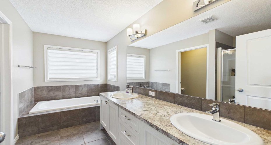 Unwind in the spa-inspired 5-piece primary ensuite, complete with double vanities, a deep soaker tub, and plenty of space to start and end your day in comfort.