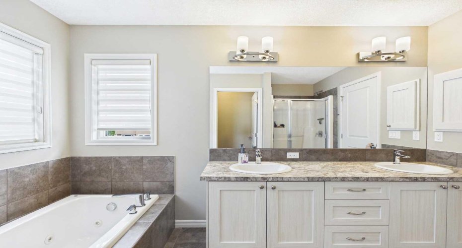 Unwind in the spa-inspired 5-piece primary ensuite, featuring double vanities, a deep soaker tub, a separate walk-in shower, and a private water closet (toilet room). Thoughtfully designed with generous space and elegant finishes, it's the perfect retreat to start and end your day in comfort.