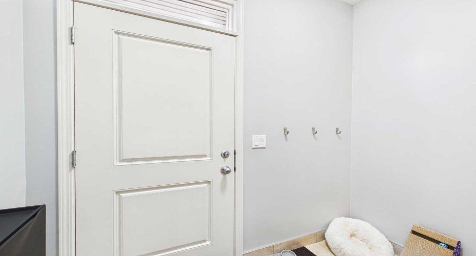 Separate side entrance leading directly to an unpermitted two-bedroom secondary suite.
