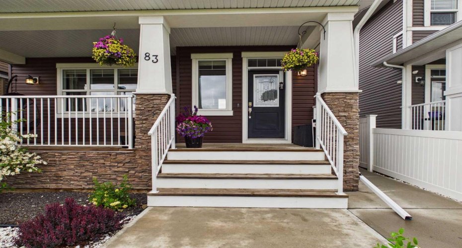 A beautiful main entrance welcomes you with poured concrete walkways and a charming front porch—the perfect place to relax and enjoy the open greenspace views with no neighbours in front.