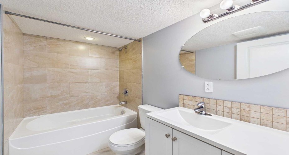4-Piece Bathroom (Illegal Basement Suite): Well-maintained 4-piece bathroom serving the illegal (non-conforming) basement suite, complete with a bathtub/shower, toilet, and vanity, offering convenience and functionality for occupants.