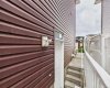 Exterior View: Side entrance providing separate access to the non-conforming (illegal) basement suite.