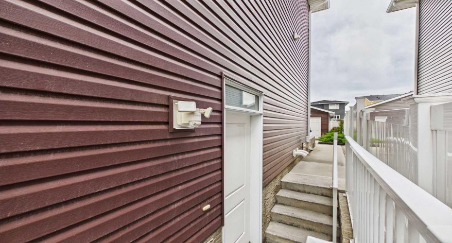 Exterior View: Side entrance providing separate access to the non-conforming (illegal) basement suite.