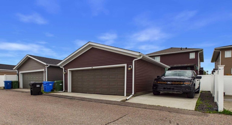 Rear Parking: Paved back alley with an additional parking stall adjacent to the garage, providing extra off-street parking and added convenience for multiple vehicles.
