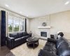 Warm and inviting main-floor living area with a cozy fireplace, flowing effortlessly through a thoughtfully designed open-concept floor Plan