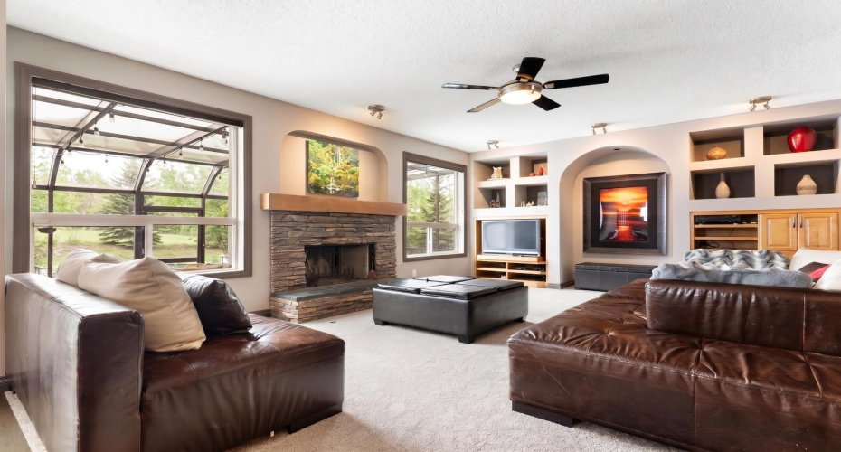 Living Room has Wood Burning Fireplace with Matching Built In Millwork