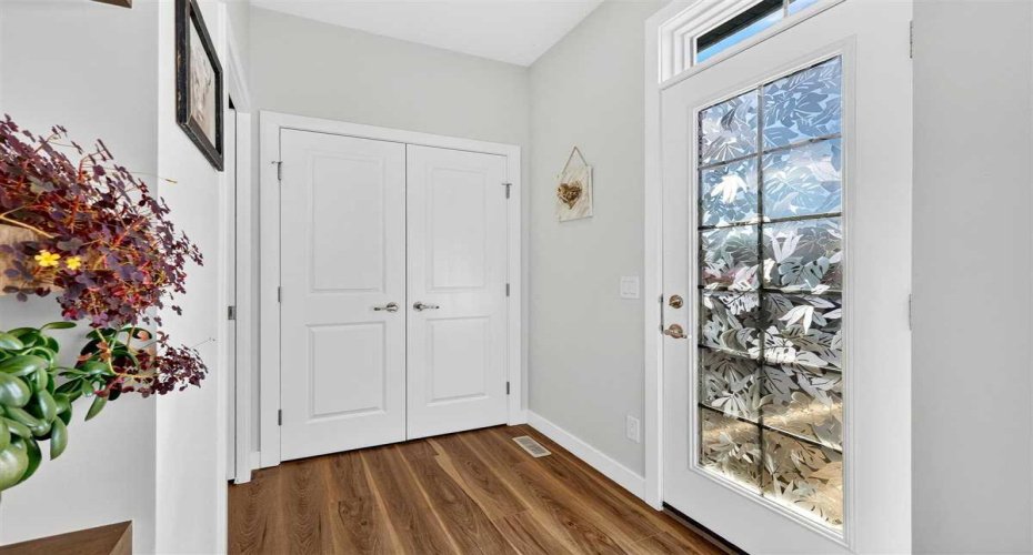 Mud room with large closet and glass french door leading to deck.