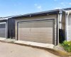 Paved back lane leads to double garage