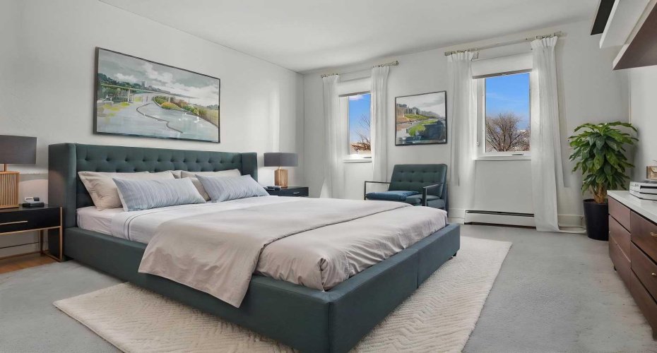 Virtually staged primary bedroom overlooking greenspace, easily accommodates king sized furniture,  new blinds and curtains