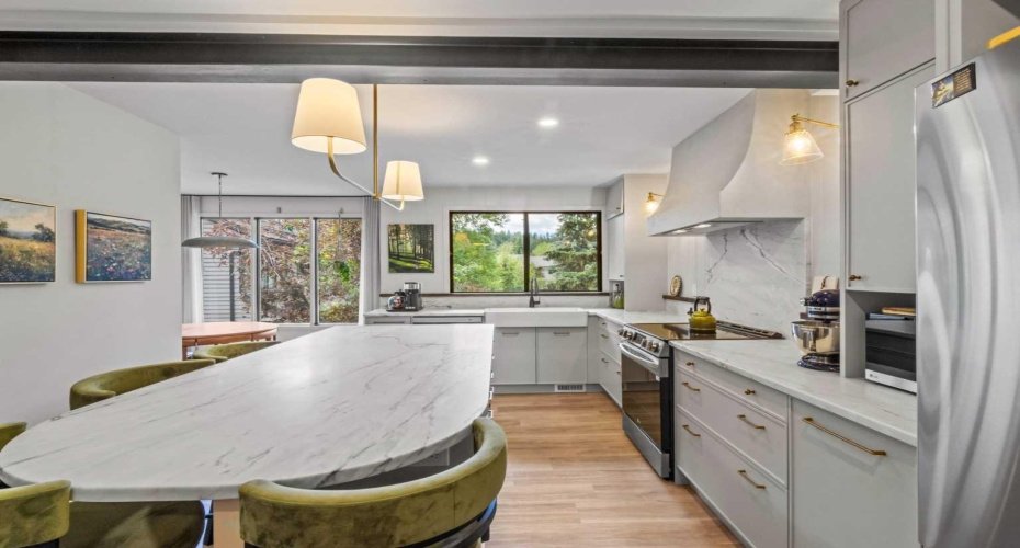 Another view of this stunning kitchen. Note the hood fan and the double farm house sink under the window.