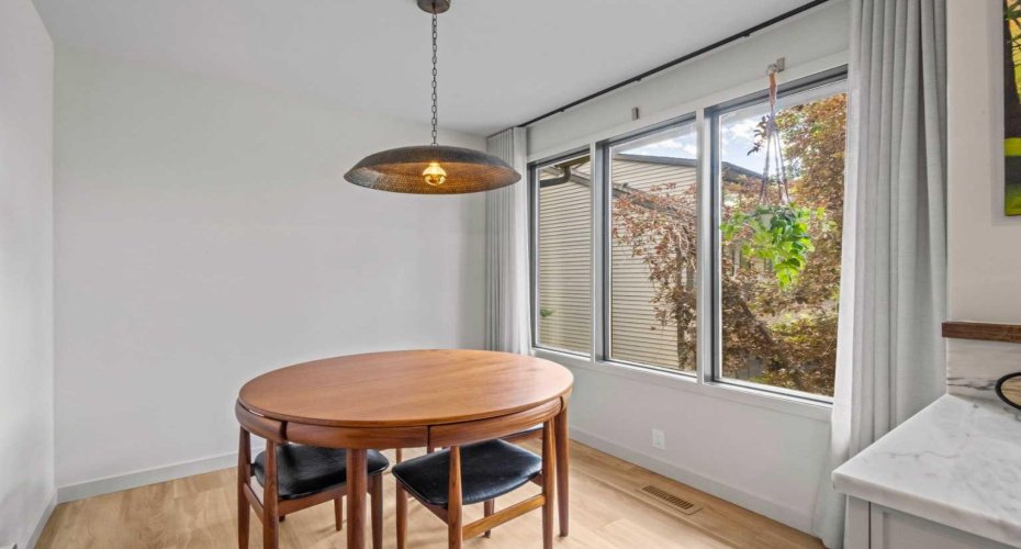 Just off of the kitchen is the dining space. A perfect place for entertaining guests with views through the large windows.