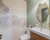 Also on the same level as the kitchen, but located in the hall by the stairs is the 2-piece powder room.