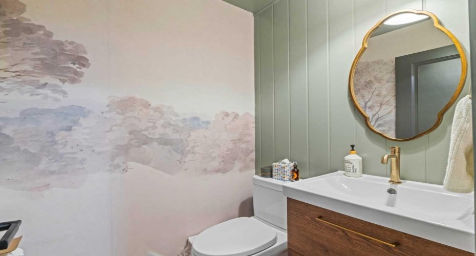 Also on the same level as the kitchen, but located in the hall by the stairs is the 2-piece powder room.