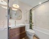 4-piece ensuite bathroom belonging to the second bedroom. Look at the soaker tub, the tile in the bath that goes to the ceiling and the brass accents.