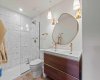 4-piece ensuite bathroom for the Primary Bedroom. Note the walk-in shower and double sinks, along with stunning brass accents.