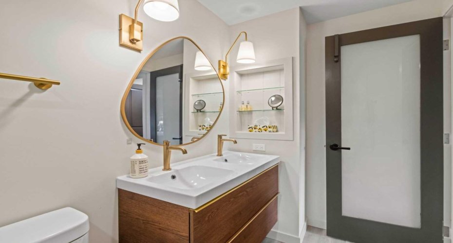 Another view of the ensuite bathroom for the Primary Bedroom. Note the door with glass inset window.