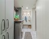 Another view of the laundry area. Check out the contemporary flooring in this lower level and all the built-in cabinetry.