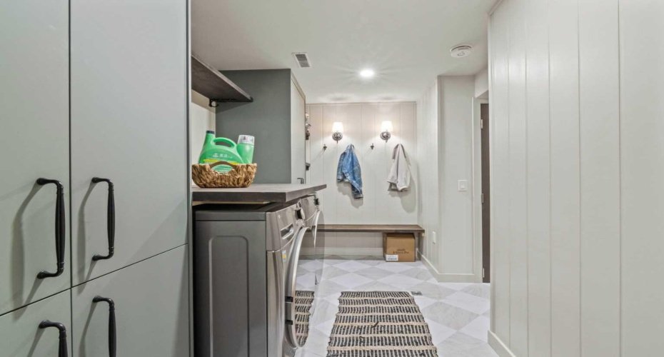 Another view of the laundry area. Check out the contemporary flooring in this lower level and all the built-in cabinetry.