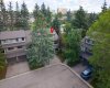 An aerial view of the unit. Note all of the greenery and many trees.