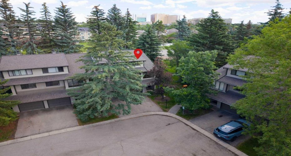 An aerial view of the unit. Note all of the greenery and many trees.