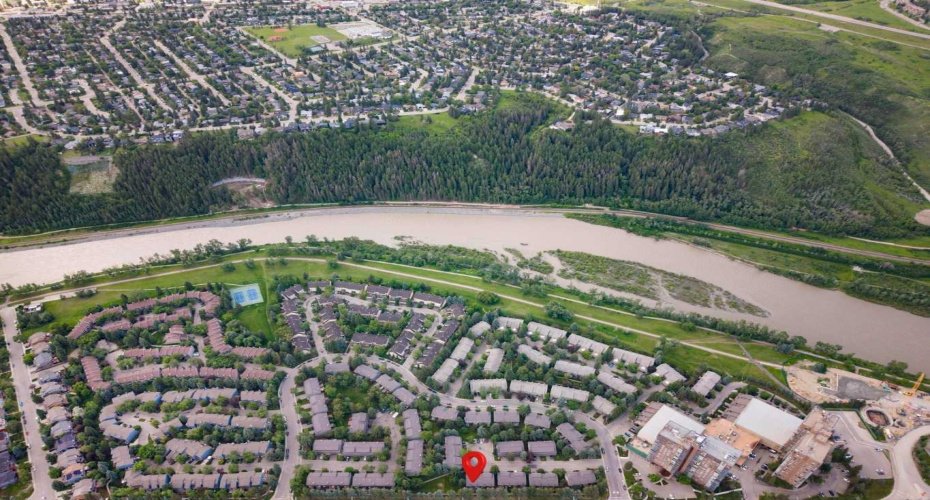 A view of the unit and the complex in the community of Point McKay in relation to the Bow River and the pathway system.