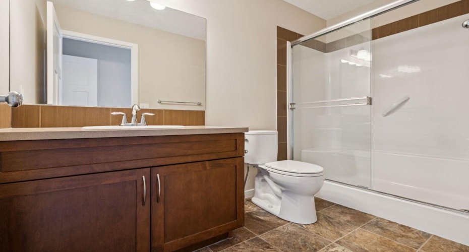 Designed for busy mornings, the spacious 3-PIECE ENSUITE BATHROOM features a large vanity, generous storage, and a practical tub/shower combination.