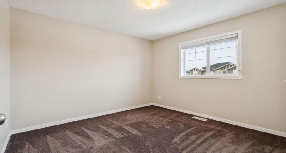 Bright and versatile, this secondary bedroom is perfect for family, guests, or a comfortable home office with plenty of natural light.