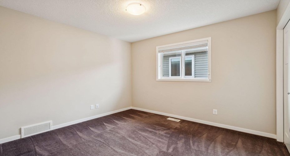 Offering a functional layout and cozy atmosphere, this spacious third bedroom adapts easily to your family's changing needs.