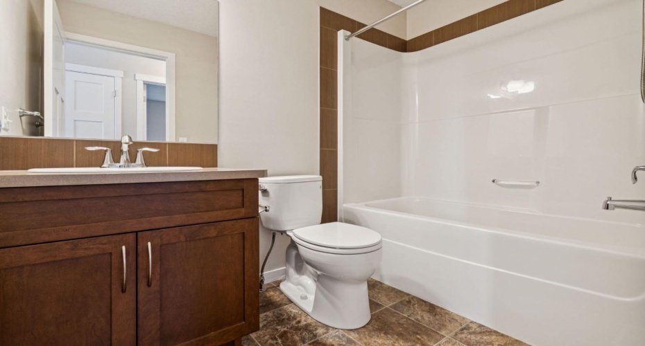 The well-appointed 4-PIECE BATHROOM features a large vanity, abundant storage, and a tub/shower combination designed for everyday convenience.