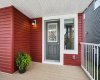 Enjoy quiet mornings and warm summer evenings from the welcoming FRONT VERANDA, a charming extension of the home that adds to its inviting curb appeal.