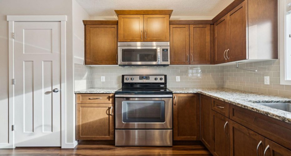 Whether you're preparing weeknight meals or hosting friends, this well-appointed kitchen offers generous prep space, timeless finishes, and a seamless layout designed for everyday living.