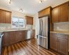 Warm cabinetry, ample counter space, and extensive storage make this inviting kitchen as practical as it is welcoming, creating the perfect space to gather and cook with ease.