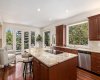 The gourmet kitchen includes custom cabinetry and a large island