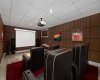 The theatre room has been completely redone with new sound-absorbing paneling  (virtually staged)