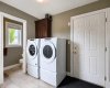 Main Floor Laundry Directly Located Off Of The Heated Garage Entrance. 2 Piece Bathroom In Background.
