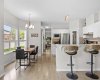 An open sightline showcases how effortlessly the dining, kitchen, and living areas connect for everyday living and hosting alike.