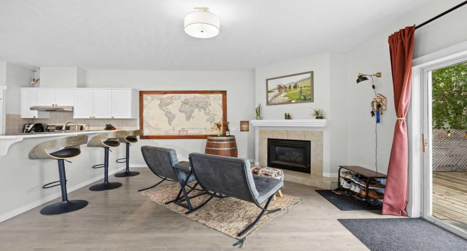 Cozy living space opens directly to the back deck through sliding doors, blending indoor comfort with outdoor living.