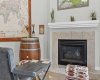 The gas fireplace!!!.....framed in tile with a clean white mantel: the warm heart of the main floor.