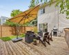 Easy access to the spacious cedar deck with a cantilever umbrella, lounge seating, and gas barbecue: your private outdoor retreat with southwest exposure.