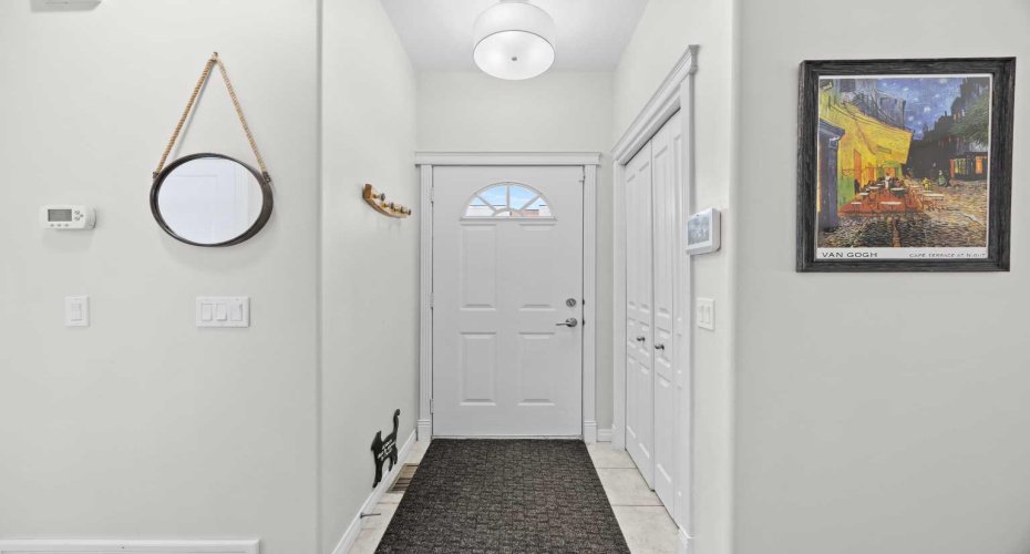 A welcoming front entry with tile flooring, ample closet storage, and a smart thermostat: the perfect first impression.