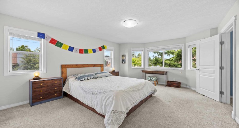 The spacious primary bedroom enjoys a bright bay window, plush new carpet, and its own private ensuite.