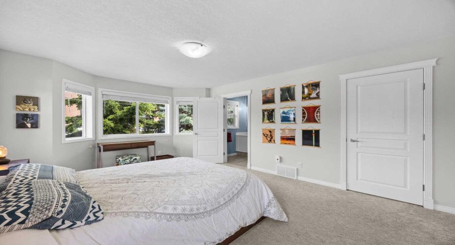 A serene primary retreat with room to unwind, a dedicated reading or work nook, and direct access to the ensuite.